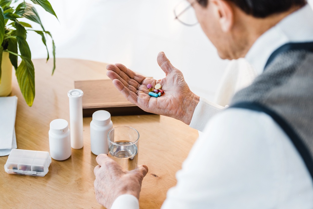 man looking at his medications to determine if drug interactions are dreaded or desired